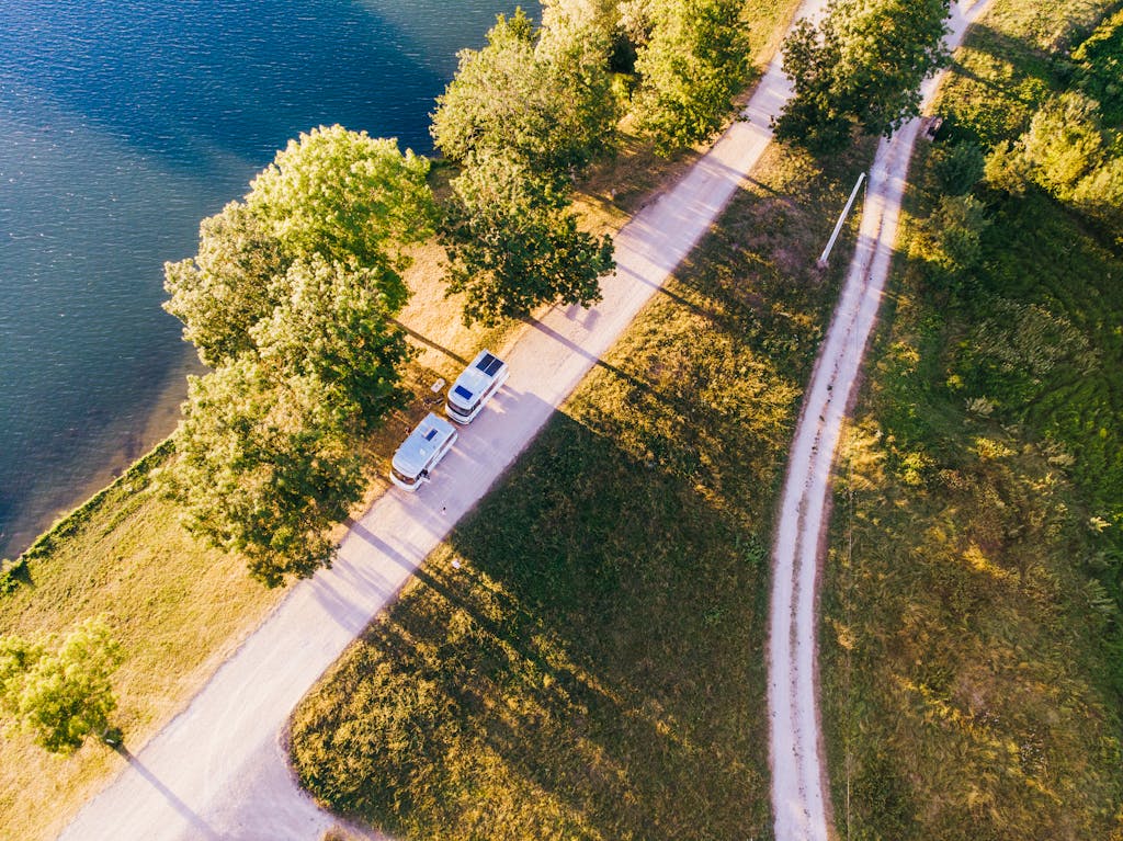 A stunning aerial view of a green agricultural field under a partly cloudy sky.